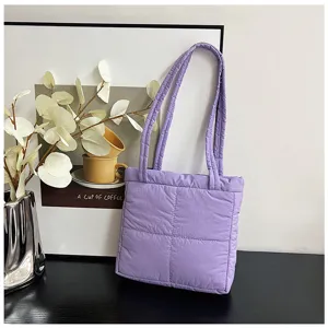 Purple nylon quilted tote bag detail shot, showing soft fabric, stitching, and twin shoulder straps.