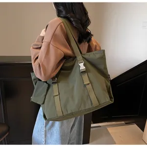Casual large capacity green canvas tote bag with buckle straps and side pocket for daily travel.