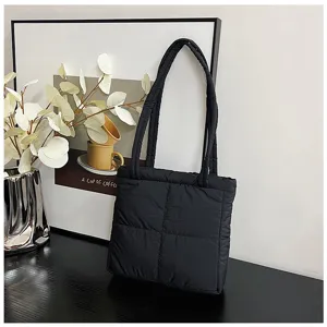 Detailed view of a soft black quilted nylon tote bag with comfortable double straps.