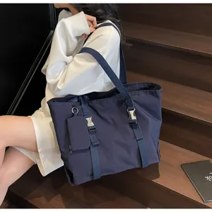 Large capacity casual dark blue canvas tote bag with shoulder straps and metal buckle closure.