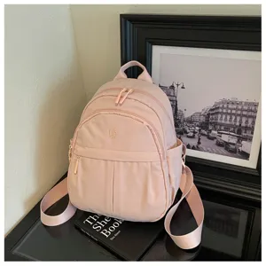 Lightweight pink nylon mini backpack for women, minimalist casual daypack for daily commute.