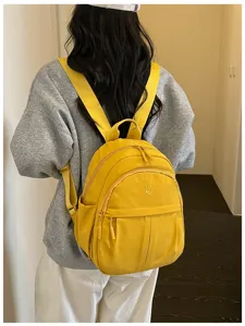 Lightweight nylon backpack for women, casual minimalist school bookbag for daily commute.