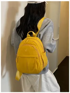 Lightweight nylon small backpack for women, casual minimalist daily commuting school bag.