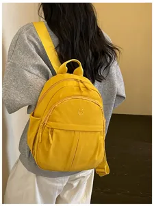 Lightweight yellow nylon casual backpack detail, stylish and practical for daily use.