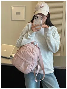 Detailed view of pink nylon mini backpack showcasing casual daily commuting style and strap.