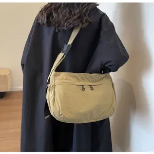 Vista dettagliata di una borsa a tracolla in nylon kaki casual, grande capacità.