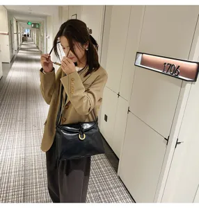 Soft leather shoulder bag, minimalist envelope design with U-buckle for women daily use.