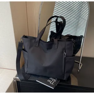 Waterproof nylon tote bag for women, large capacity casual shoulder and crossbody bag with zipper.