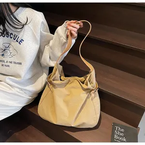 Casual lightweight nylon shoulder bag for women, simple daily commuter tote bag with slim strap.