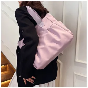 Large capacity pink nylon tote bag for women, stylish shoulder handbag for commute.