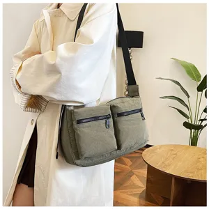 Casual daily multi-pocket canvas crossbody bag for women, stylish and practical messenger bag.