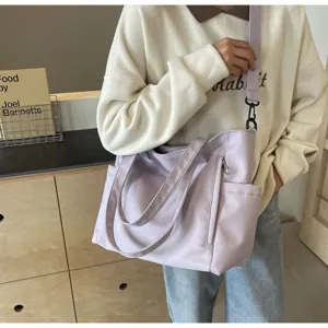 Detail view of large capacity waterproof nylon tote bag, casual solid color shoulder bag.