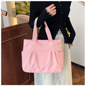 Large capacity pink nylon tote bag for women, casual commuter shoulder bag with side pockets.