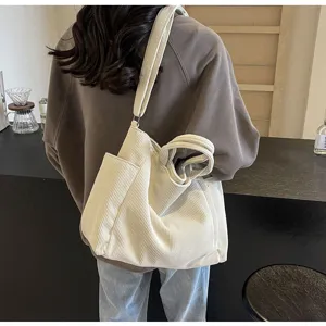 Detail view of casual corduroy tote bag showing spacious interior, soft texture, and dual handles.