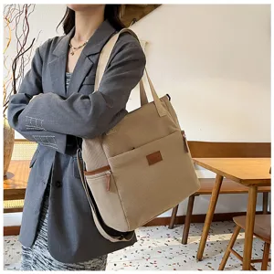 Detailed view of large capacity corduroy shoulder tote bag in stylish beige everyday use.