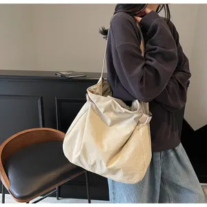 Minimalist casual nylon shoulder bag detail, lightweight daily commuter tote handbag.