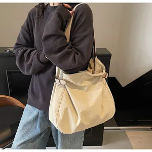 Lightweight minimalist nylon shoulder tote bag, casual daily commuter handbag with side buckles.