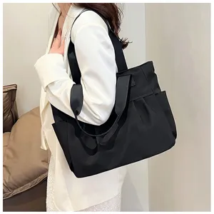 Detail view of a large capacity black nylon tote bag, perfect for daily commuting and office use.