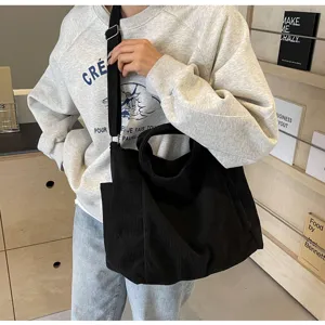 Black corduroy tote bag detail view, casual shoulder bag with spacious capacity, daily use.