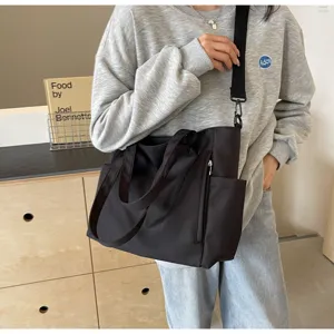 Black nylon tote bag for women, large capacity casual shoulder cross-body bag, waterproof daily use.