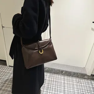 Minimalist brown leather shoulder bag, soft envelope crossbody bag with metal ring and braid.