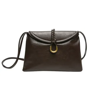 Minimalist dark brown leather shoulder bag for women, elegant envelope crossbody bag style.