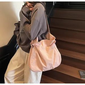 Minimalist pink nylon shoulder bag, lightweight casual tote handbag for women daily work.