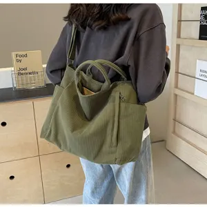 Corduroy tote bag detail showing large capacity, comfortable shoulder strap, and durable olive green fabric.