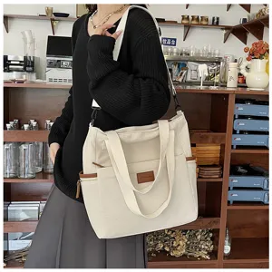 Corduroy tote bag detail showing large capacity, dual handles, and side pocket design.