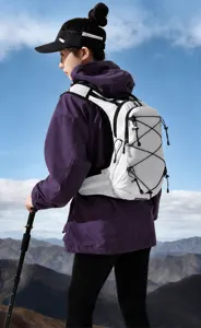 Detailed shot of white outdoor hiking backpack with breathable straps and elastic bungee cords.