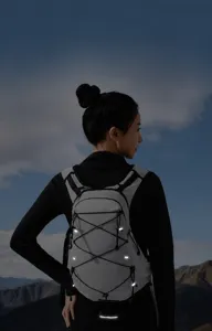 Outdoor sports backpack detail showing reflective strips and breathable straps for night safety hiking.