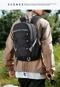 Detailed view of outdoor backpack with durable black fabric and elastic cords for hiking camping.