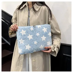 Fluffy blue laptop sleeve with white star pattern, cute plush tablet storage bag for daily use.