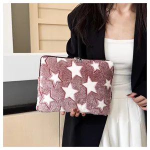Plush laptop sleeve detail featuring a cozy star pattern and soft texture for daily use.