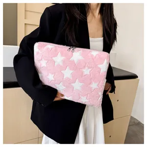 Close-up detail of the pink star plush laptop sleeve, showing soft fabric and zipper.