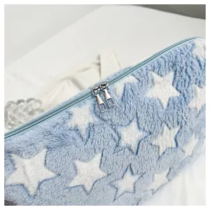Close up of the fluffy star pattern plush laptop sleeve detail, showing soft texture.