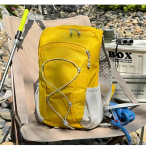 Bright yellow outdoor hiking backpack with mesh pockets and bungee cord for camping travel.