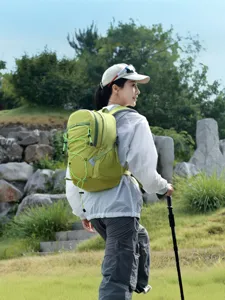 Durable outdoor hiking backpack with elastic cord, lightweight green daypack for camping.