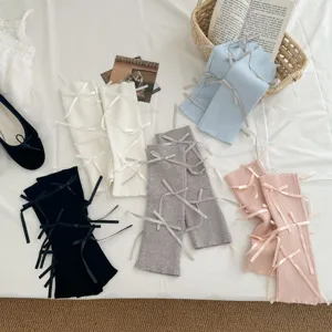 Sweet Japanese Lolita leg warmers with vertical stripes and bows, versatile autumn fashion.