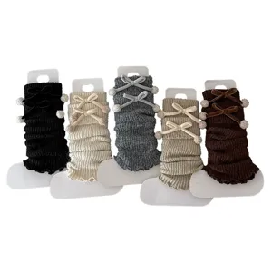 Knitted leg warmers with velvet bows and pom poms, winter warm boot cuffs in multi colors.
