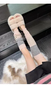 Cozy color-blocked knit leg warmers detail paired with fuzzy slippers for winter daily outfit.
