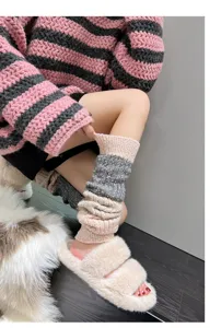 Detailed view of colorful knitted wool leg warmers, cozy autumn winter fashion accessory.
