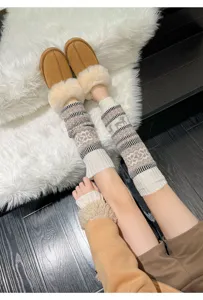 Cozy knit leg warmers detail shot, stylish winter warm knitted socks with plush shoes.