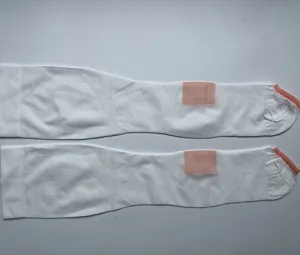 Details of white open toe anti embolism compression stockings with pink mesh detail, flat lay.