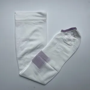 Detail view of white open-toe compression calf socks with purple cuff and non-slip sole pattern.