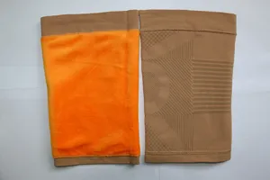 Detailed view of thermal fleece-lined knee sleeve showing orange inner plush and knit exterior.