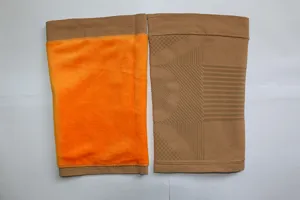 Thermal fleece-lined knee warmers detail shot showing plush orange inside and brown knit exterior.