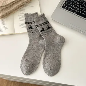 Cozy Nordic style wool blend mid-tube socks featuring cute reindeer and snowflake patterns.