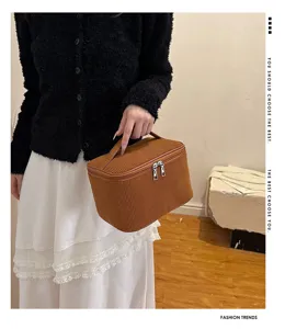Detailed view of the brown corduroy cosmetic bag showing fine texture and zipper.