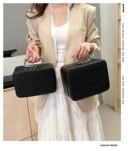 Black quilted cosmetic bag with metal handle, large capacity makeup storage box for women.